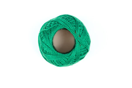 Single green sewing thread on a white backgroundの写真素材