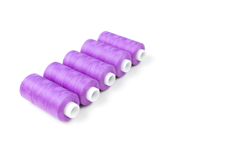 Five violet purple sewing threads on white background. Textile backgroundの写真素材