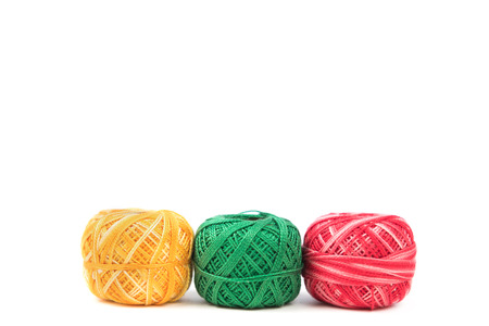 Text ready background, colorful sewing threads on white surface.