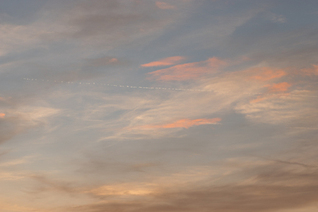 Evening blue sky with colorful clouds. Sky with clouds as background or wallpaper. Beautiful sunsetの写真素材