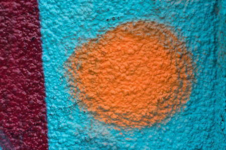 Orange and red graffiti details on a blue painted wall, facade. Abstract background, wallpaperの写真素材