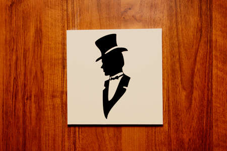 plaque on the door indicating the men's roomの写真素材