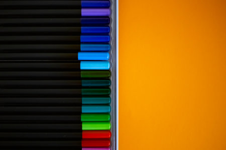 Colored pencils for creative idea and concept. Drawing and painting. Learn from home concept. Drawing and art education. Set of colorful pencils on orange background, top viewの写真素材