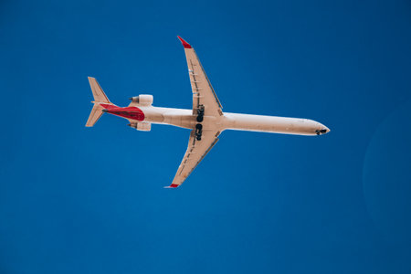 Italy, Lombardy, Milan 1.12.2023. Airplane against blue sky. The plane lands at the Italian airport Linateのeditorial素材