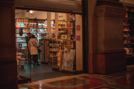 Milan, Italy 15.12.2023. Shop window in the center of Milan in the evening with many tourists. Shopping in Milan during the Christmas holidaysの写真素材