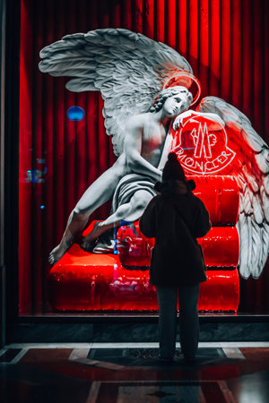 Moncler Italy Official Store.Shopping in Milan. Girl near a beautiful showcase Moncler in Milan Galleria Vittorio Emanuele. Italia, Milano 01.01.2024のeditorial素材