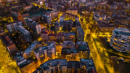 Streets, roads and roofs of the night city from above. Night city concept. Milan, Italyの写真素材