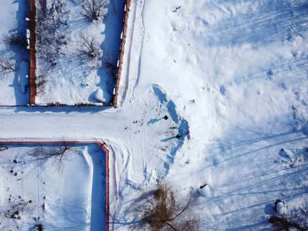 Winter drone footage of a village. Top view of snowy groundの写真素材