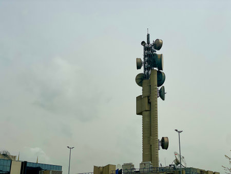 Telecommunication tower of 4G and 5G cellular. Macro Base Station. 5G radio network telecommunication equipment with radio modules and smart antennas against the background of a cloudy skyの写真素材