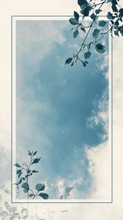 Frame with green leaves on blue sky background. Copy space for textの素材