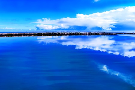 reflection of clouds in the sea on the horizonの写真素材
