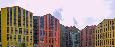 view at modern courtyard between apartment buildings, bright colored multi-story apartment buildingsのeditorial素材