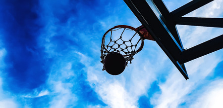 basketball hoop and ball on the sky background