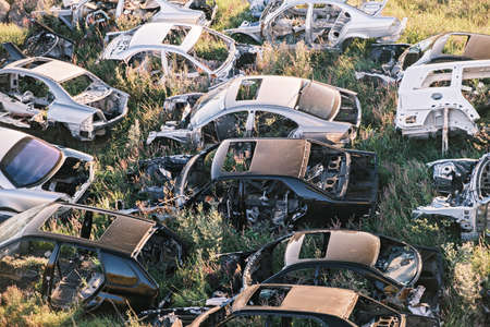 Car dump. A bunch of old rotten broken cars in the field. Top viewの写真素材