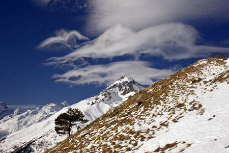 semenov-bashi peak winter with beautiful clouds and the caucasus. russiaの写真素材