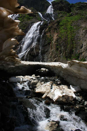 Waterfalls and glaciers and green valleys. Exotic picture - ice, water, forest, summer in one paletteの写真素材