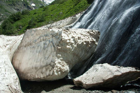 Waterfalls and glaciers and green valleys. Exotic picture - ice, water, forest, summer in one paletteの写真素材