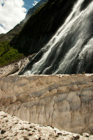 Waterfalls and glaciers and green valleys. Exotic picture - ice, water, forest, summer in one paletteの写真素材
