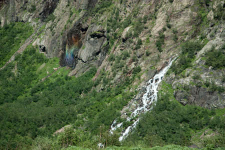 Unusual rainbow on the waterfall in the form of Christの写真素材