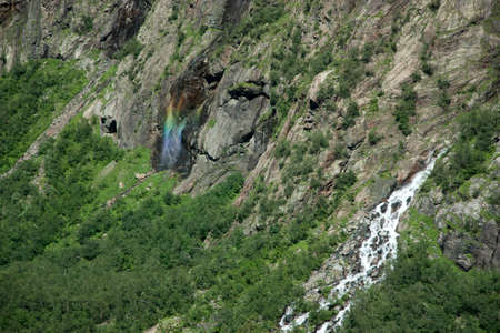 Unusual rainbow on the waterfall in the form of Christの写真素材
