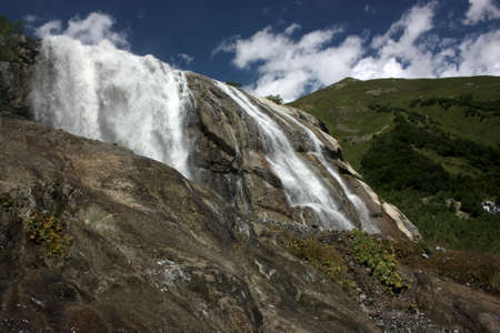 Waterfalls and glaciers and green valleys. Exotic picture - ice, water, forest, summer in one paletteの写真素材