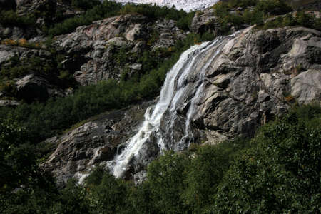 Waterfalls and glaciers and green valleys. Exotic picture - ice, water, forest, summer in one paletteの写真素材