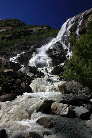 Waterfalls and glaciers and green valleys. Exotic picture - ice, water, forest, summer in one paletteの写真素材