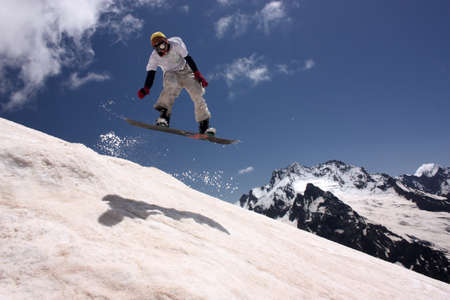 Snowboarder in the mountains, summer skiing on the board