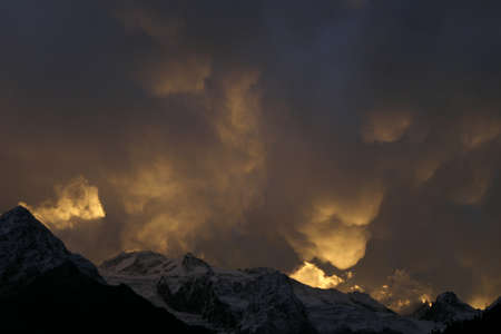 Mammatus Clouds, red sunset in the mountainsの写真素材