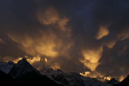 Mammatus Clouds, red sunset in the mountainsの写真素材
