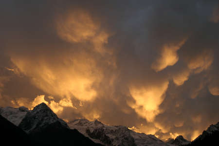 Mammatus Clouds, red sunset in the mountainsの写真素材