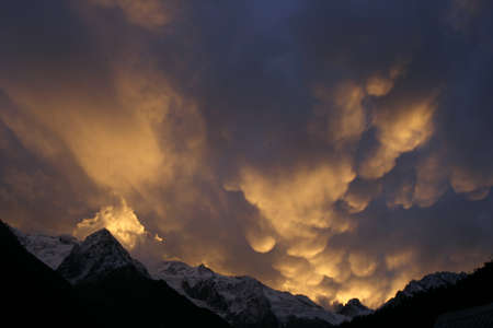 Mammatus Clouds, red sunset in the mountainsの写真素材