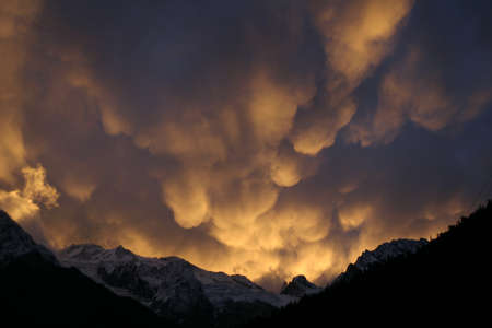 Mammatus Clouds, red sunset in the mountainsの写真素材