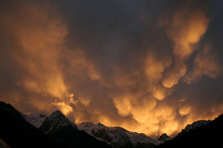 Mammatus Clouds, red sunset in the mountainsの写真素材