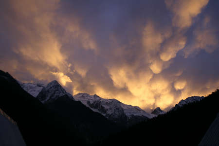 Mammatus Clouds, red sunset in the mountainsの写真素材