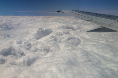 View from window of a jet plane wing with beautiful weatherの写真素材