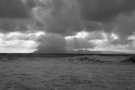 Cloudy seascape with clouds and sun raysの写真素材