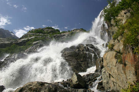 Alpine waterfall in mountain. waterfall on the river in the mountainsの写真素材