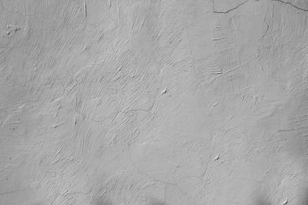 white lime, plastered walls with cracks and irregularitiesの写真素材