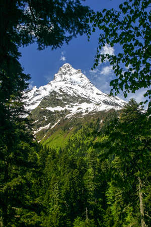 Scenery of high mountain with clouds on a clear dayの写真素材