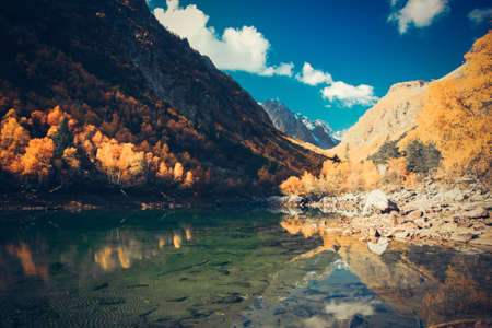 Scenery of high mountain with lake and high peak on a clear day. Pure mountain water. Clear mountain lakes in the Alpine area.の写真素材