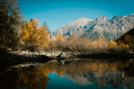 Scenery of high mountain with lake and high peak on a clear day. Pure mountain water. Clear mountain lakes in the Alpine area.の写真素材
