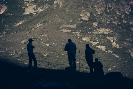 Travelers in the mountains. Mountain landscape and people on the roadの写真素材