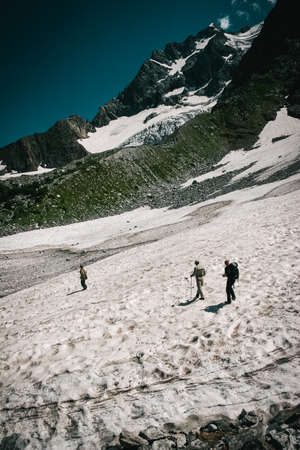 Travelers in the mountains. Mountain landscape and people on the roadの写真素材