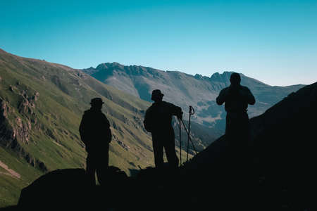 Travelers in the mountains. Mountain landscape and people on the roadの写真素材