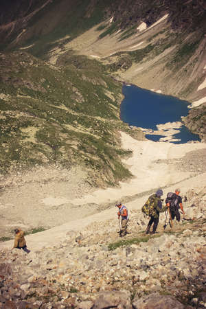 Travelers in the mountains. Mountain landscape and people on the road