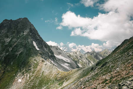 Mountain landscape with clouds. Peaks and valleys in the summer seasonの写真素材