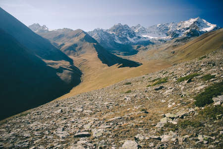 The mountain autumn landscape with colorful forest and high peaks Caucasus Mountains