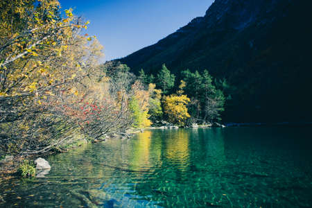 Scenery of high mountain with lake and high peak on a clear day. Pure mountain water. Clear mountain lakes in the Alpine area.の写真素材