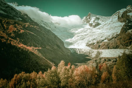 Mountain Valley, Alpine landscape areas. Panoramic view of mountains, trees, glacier.の写真素材